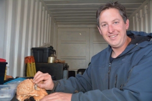 Jesse at Drimolen during the 2016 season comparing a new hominin fossil to the DNH7 skull